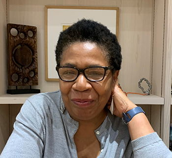 A woman sitting and smiling